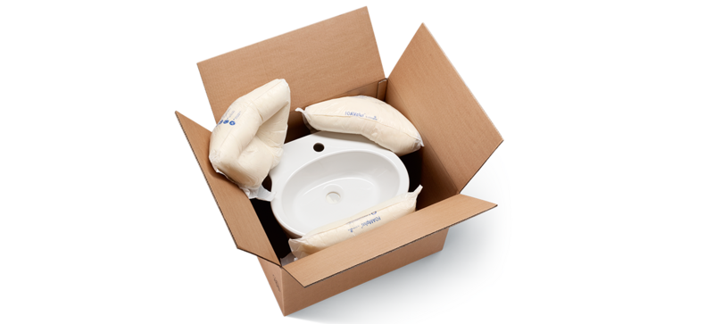 A cardboard box containing a washbasin and foam packaging