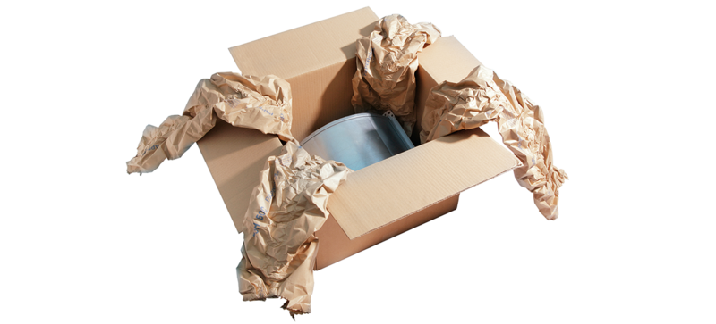 A cardboard box containing a component and brown paper cushioning